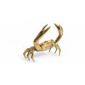 Golden brass crab sculpture with raised claws